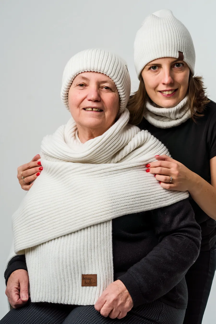 Two generations — grandmother and daughter in BerryBoat hats and scarf
